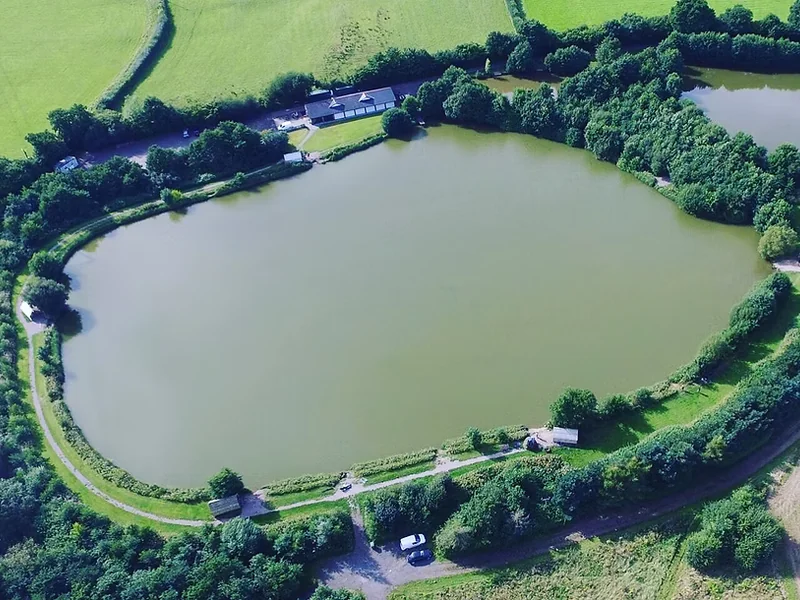 A scenic view of Lodge Lake at the Cefn Mably Lakes fishery.