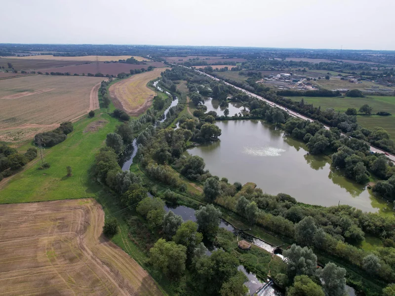 An aerial view of Specimen 1 at A12 Lakes, showing the two islands and clear water.