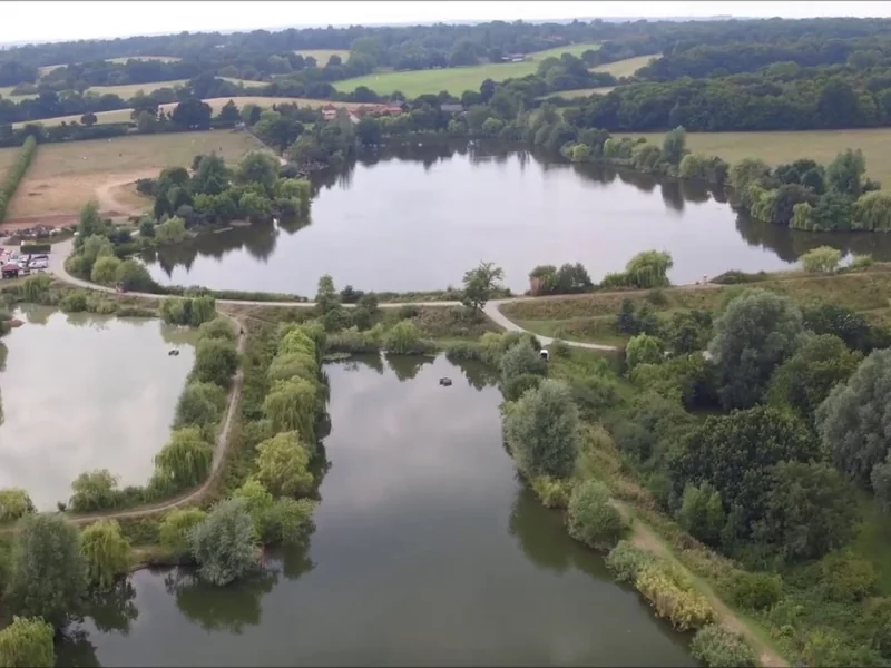 An aerial view of the stunning Valley Lake at Fryerning Fisheries, Essex.