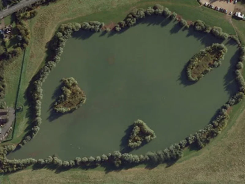 A panoramic view of the main lake at Thorpe Lea Fishery in Surrey.