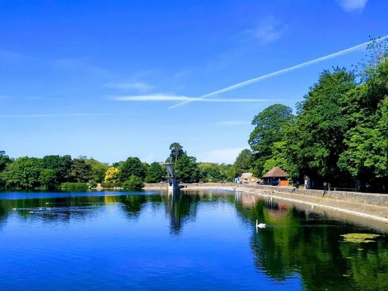 An angler's view across the vast Coate Water lake on a calm day.
